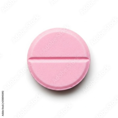 Pink round pill with score line isolated on white background