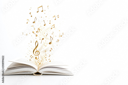 Open book releasing golden music notes concept melody creativity white background