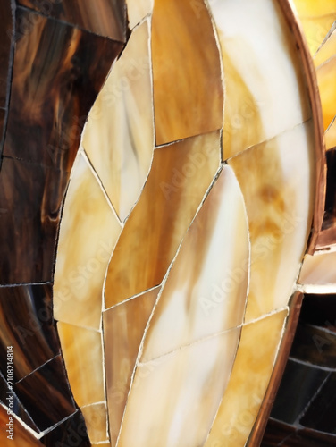 Close-up of a colorful mosaic made of ceramic fragments. Abstract texture, decorative art, handmade craftsmanship, detailed mosaic pattern.
