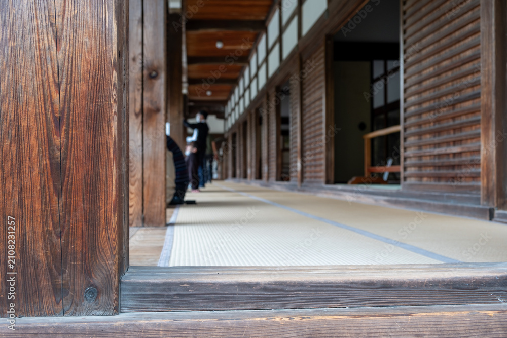 Fototapeta premium Tatami Corridor With Wood Pillars Inside Japanese Temple Building on Spring Day