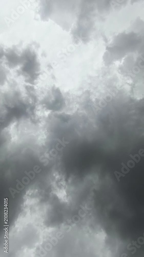 A low-angle time lapse video of dark storm clouds moving dramatically across the overcast sky before a heavy rain