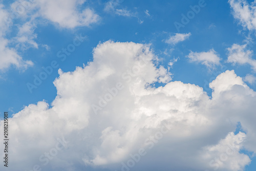 Bild auf Leinwand Bright clouds float in the blue sky during the afternoon on a clear day