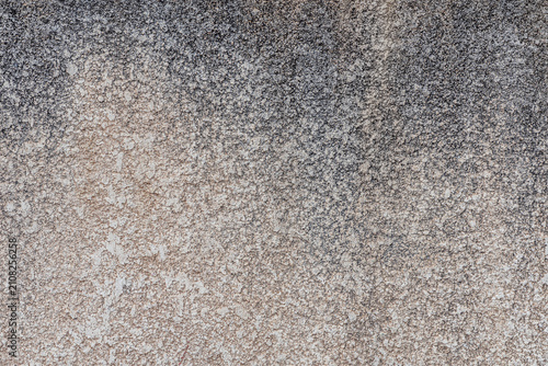 Rough weathered plaster wall with natural gray and beige tones. Abstract grunge surface with fine mineral texture 