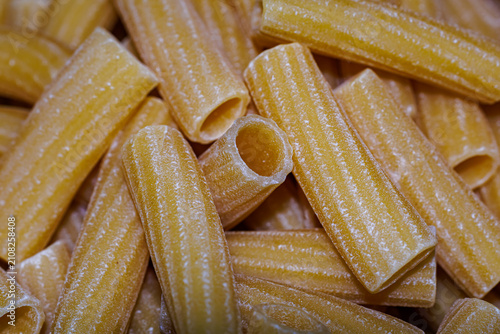 Obraz na plátně Raw rigatoni pasta close-up, texture of dry Italian unbaked tubular pasta backgr