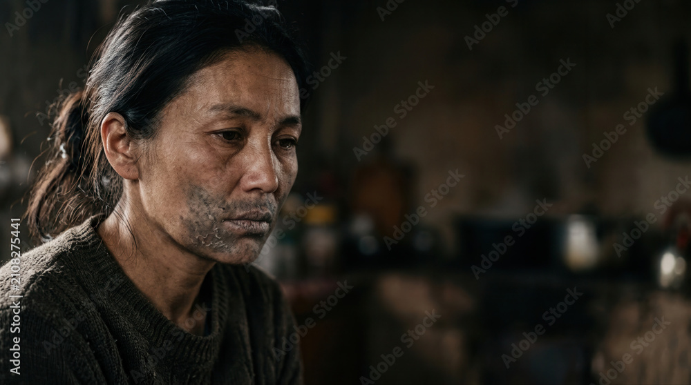 Fototapeta premium Portrait of a woman reflecting on the dangers of smoking and lung health in a dimly lit kitchen environment