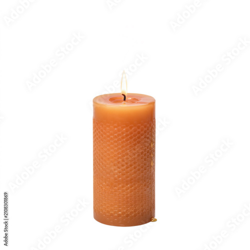 Tall beeswax pillar candle with honeycomb texture burning gently with a soft flame isolated on transparent background