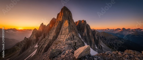 Majestic Mountain Landscape at Sunrise with Stunning Peaks Illuminated by Golden Light in the Rocky Terrain under a Clear Sky