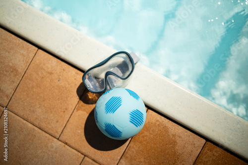 Foto Swimming pool accessories including mask and ball for summer leisure