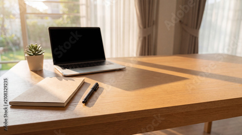 Laptop Notebook and Pen on Wooden Desk in Home Office