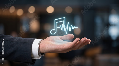 Business hand presenting digital music streaming and audio waveform technology interface