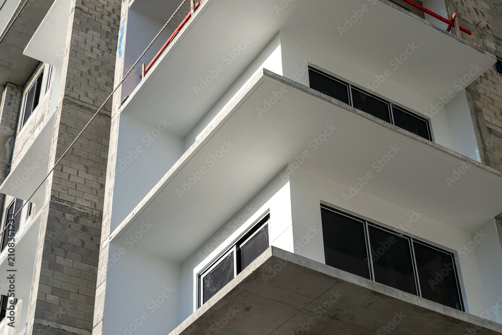 Fototapeta premium Modern building balconies under construction with concrete architecture