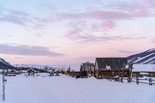 Fotografie Snow covered wooden houses in Hemu Village during winter, Xinjiang, China