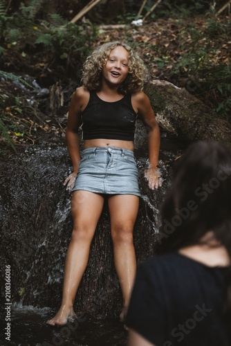 Laughing Girl Enjoying Creek Waterfall in Summer