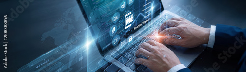 Фотография Finance manager is diligently managing digital assets using laptop for the Mobile Wallets systems network protocols to ensure absolute data protection