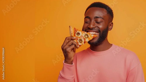 A man enjoying a slice of pizza with a satisfied smile, against a bold orange background