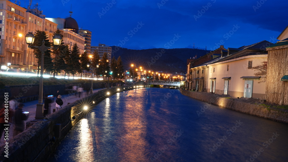 Obraz premium The harbour and port view with the old buildings and river as background at night