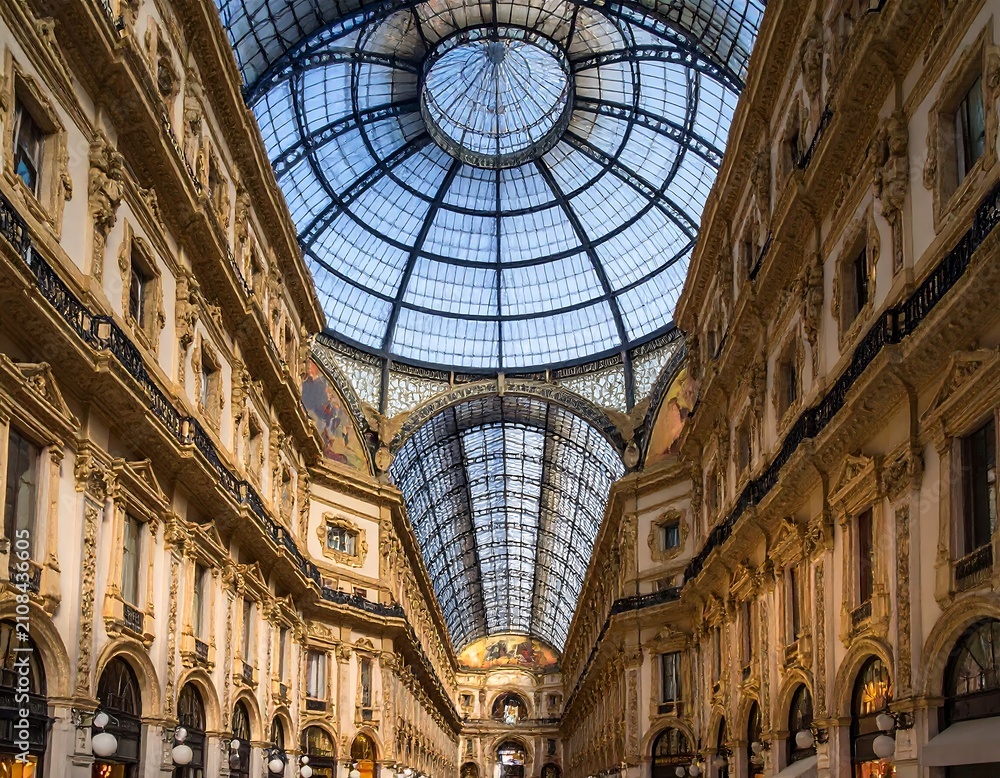 Obraz premium Ornate architectural interior featuring a high glass dome, intricate detailing, and symmetrical composition. Sunlight streams in