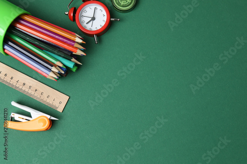 Colorful school supplies flat lay on colored chalkboard with notepad, pencil, ruler and September tag, perfect for education, learning and classroom design.