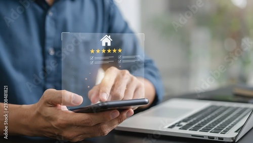 Person using smartphone to leave a five star review for a home service online