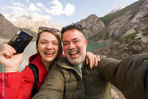 Couple Takes Selfie by Mountain Lake in Haft Kul, Tajikistan
