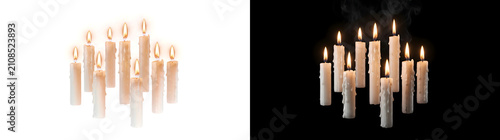 фотографія White wax candles group of varying heights burning with dripping wax and gentle