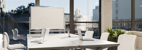 3D Illustration of Modern Office Workplace Conference Room with Laptops, Whiteboard, and City View