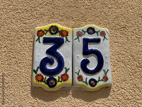 Hand painted ceramic tiles that say number 35