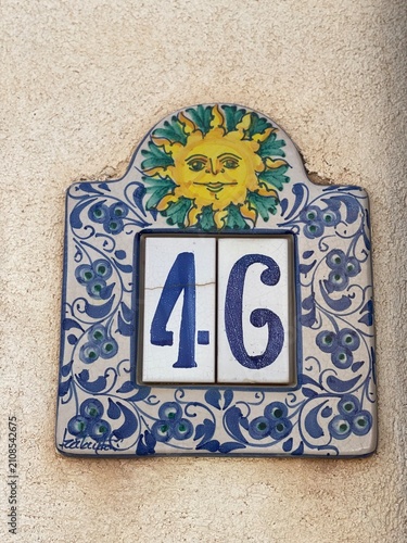 Hand painted ceramic tiles that say number 46