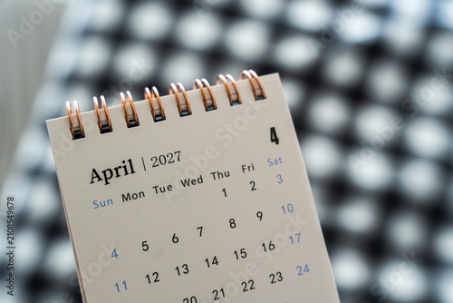 Handwritten calendar page showing April 2027 on a stylish checkered background, symbolizing time management and planning, ideal for business and personal organization use.