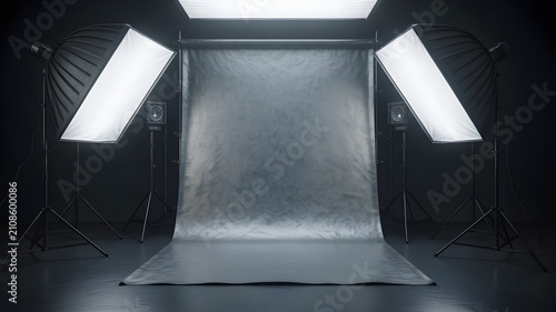 Professional photography studio setup with a grey backdrop, softbox lighting, and equipment, ready for a portrait or product photoshoot