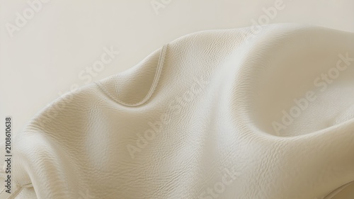 Abstract closeup of soft, draped offwhite leather or fabric texture with gentle folds and shadows