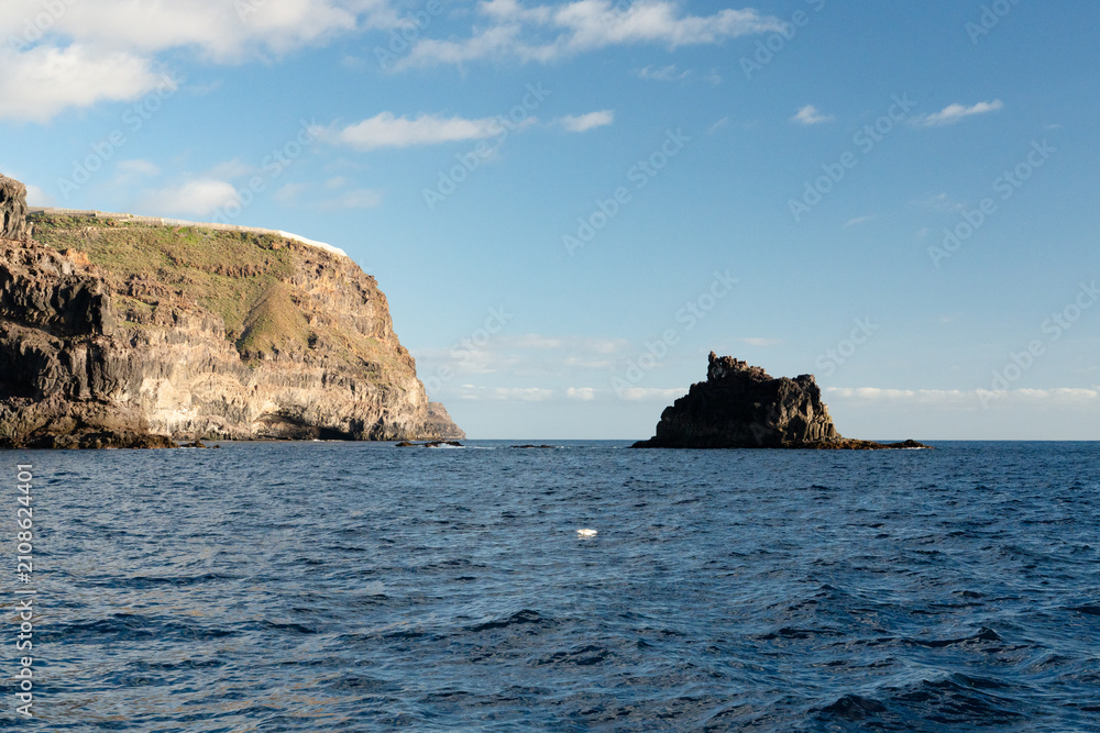 Fototapeta premium Volcanic sea stack and clifftop settlement on the coast of La Gomera Canary Islands Spain