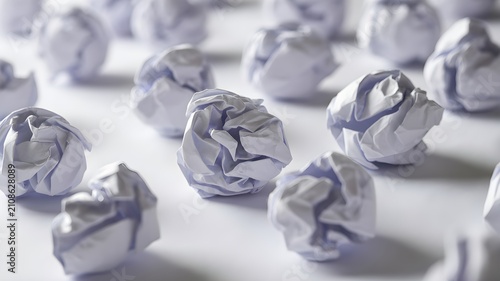 Group of crumpled white paper balls arranged in a pattern, isolated on white background, concept of brainstorming, failure, or creative process