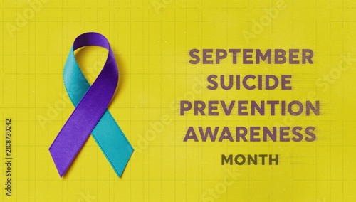 September suicide prevention awareness month concept with teal and purple ribbon on a yellow grid background