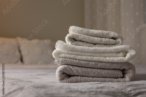 Canvastavla Fresh Folded Towels on Bed in Cozy Bedroom Interior