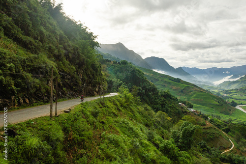 Winding Mountain Road and Motorcyclist Overlooking Sapa Valley