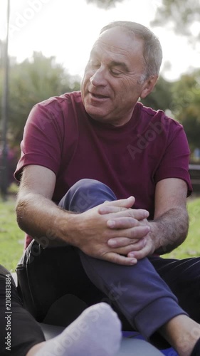 Senior man have fun talking with friends after yoga class outdoor at park city - Elderly community concept - Vertical video