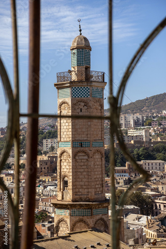 Mosque Minaret with Turquoise Checkerboard Tiles Viewed Through Iron Window Grille from Bey Palace