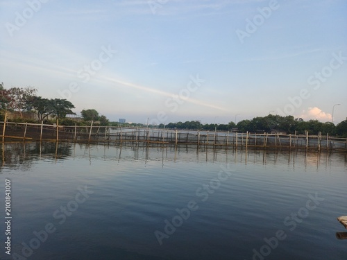 Perfect reflection of soft cloudy sky on smooth calm undisturbed water surface. Nature landscape concept
