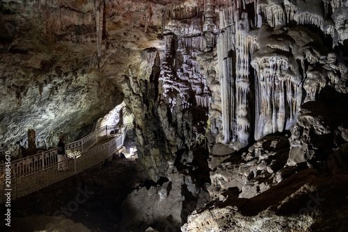 Metal Walkway Curving Through Dramatic Stalactite and Stalagmite Forest in Les Grottes des Beni Add