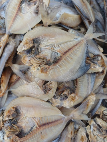 Canvas Print Flat split dried salted fish arranged in dense overlapping layers