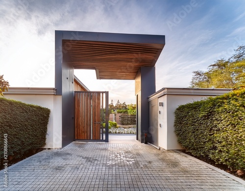 a main gate design with a cantilevered structure creating a sense of weightlessness and architectural intrigue that adds a touch of drama to the entrance of the modern house in