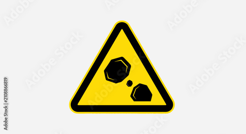Yellow road sign with rocks warning.