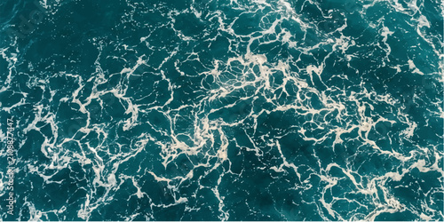 Close-up aerial view of churning ocean waves creating intricate patterns of foam and turquoise water, evoking the power and beauty of the sea.
