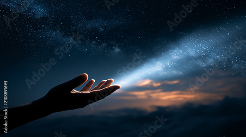 Glowing starlight beam streaming into an open human hand at night under a starry sky