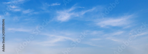 Clear blue sky with wispy clouds above