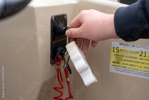 Turning the ignition key on a boat console