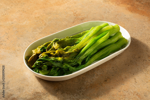 Canvastavla A view of a plate of blanched yu choi.