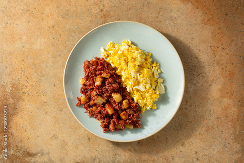 Принти на полотні A top down view of a plate of corned beef hash and scrambled eggs