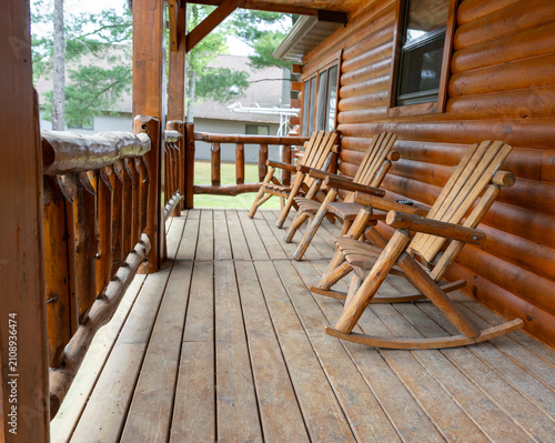 Wooden rocking chairs on a rustic cabin porch